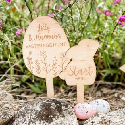 Bandicute's Personalised Easter Egg Hunt Stakes displayed in a garden with Easter eggs.