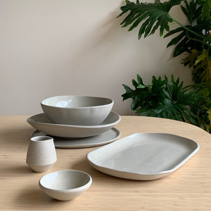 A collection of Adele Macer Ceramics, including a mug, bowl and tray.