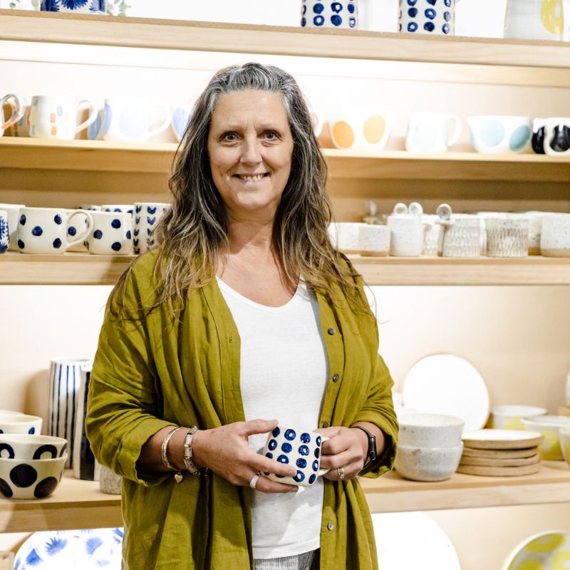 Handmade Ambassador Photo of Susi from Red Fox Pottery in front of her ceramics stall