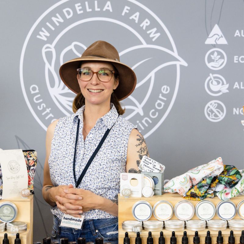 Sarah from Windella Farm standing behind her skincare stall smiling at the camera